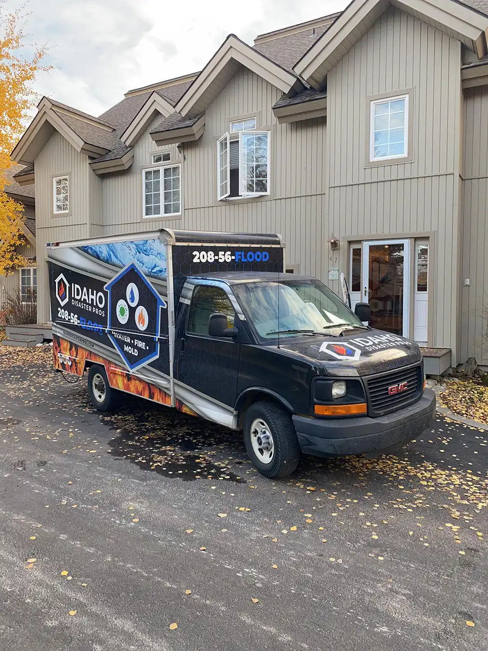 Idaho Disaster Pros work truck outside of brown home